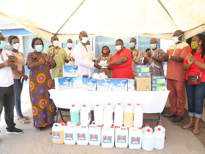 Mrs. Christa Osei-Mensah presenting the items to Dr. Evans Ekanem